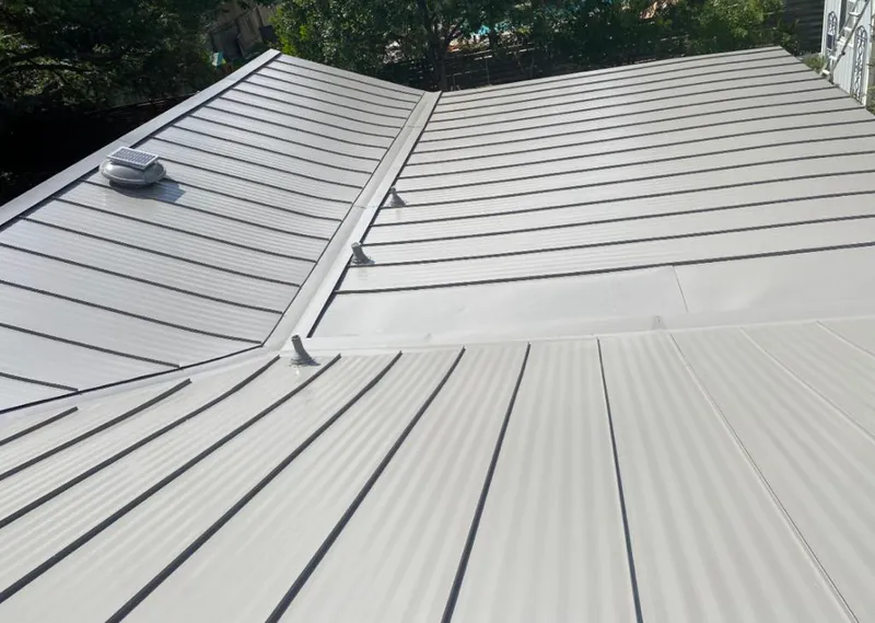 Solar attic fan installed on a metal roof for Roof Ventilation in Eastchester